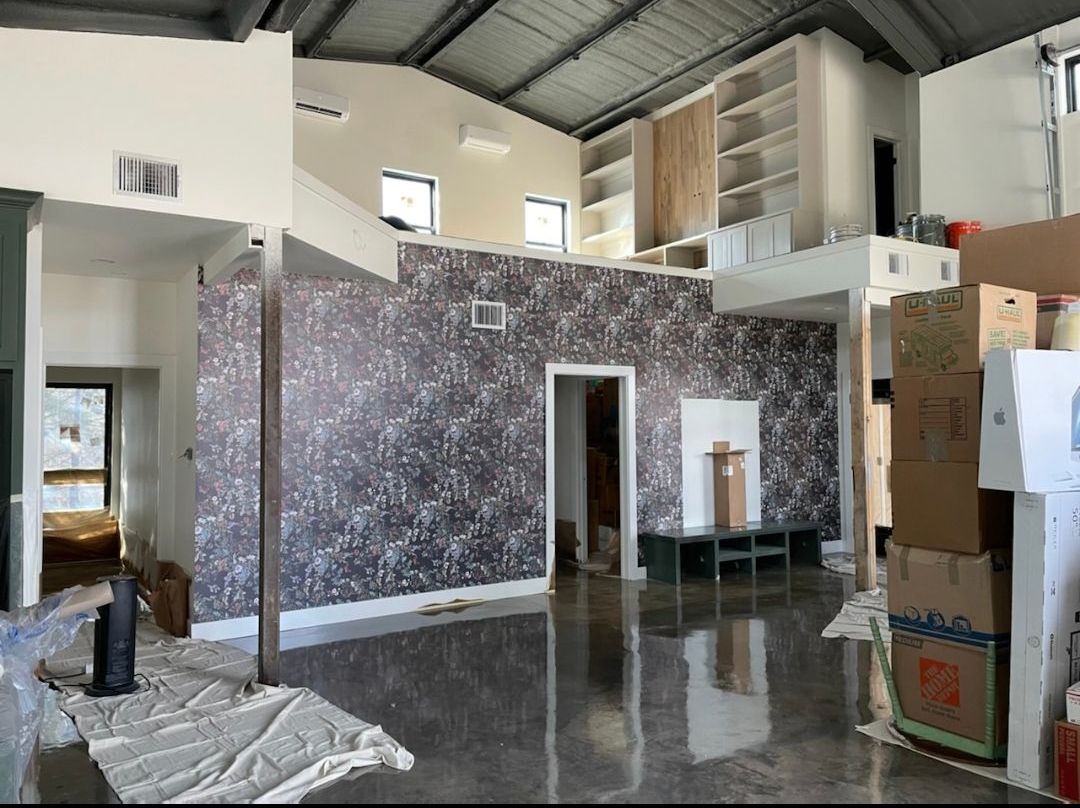 A large empty room with a lot of boxes on the floor