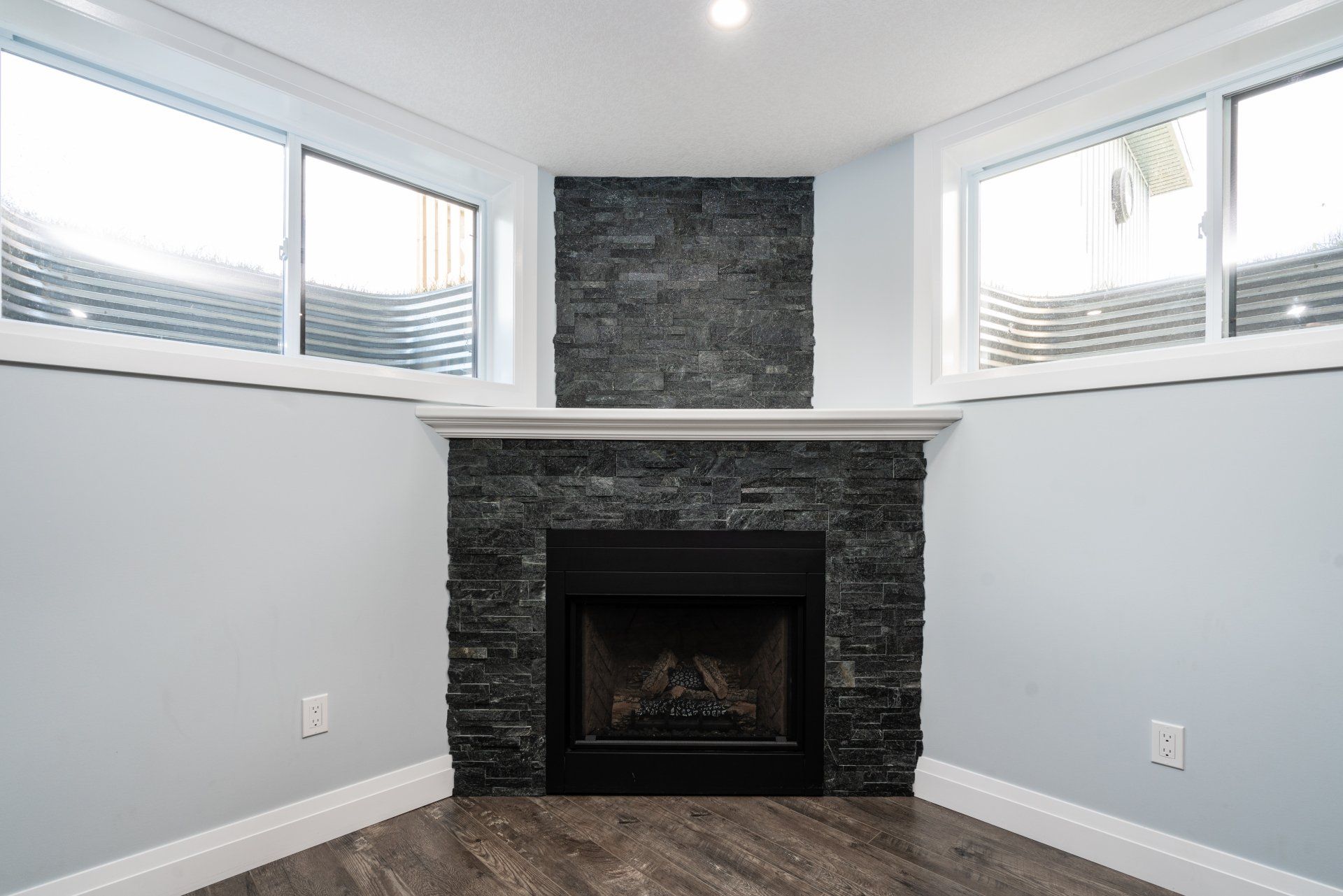 There is a fireplace in the corner of the room.