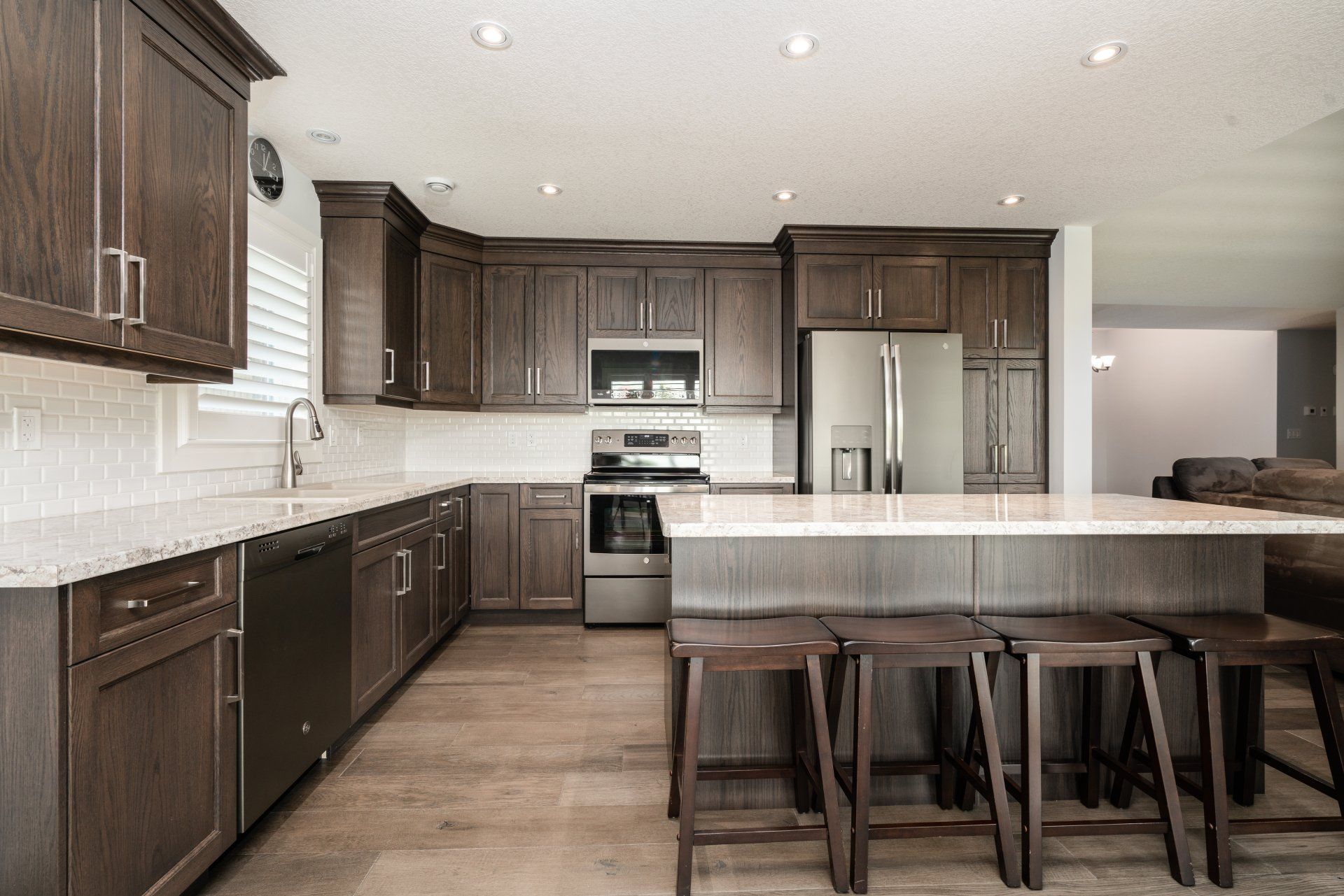 A kitchen with stainless steel appliances and wooden cabinets.