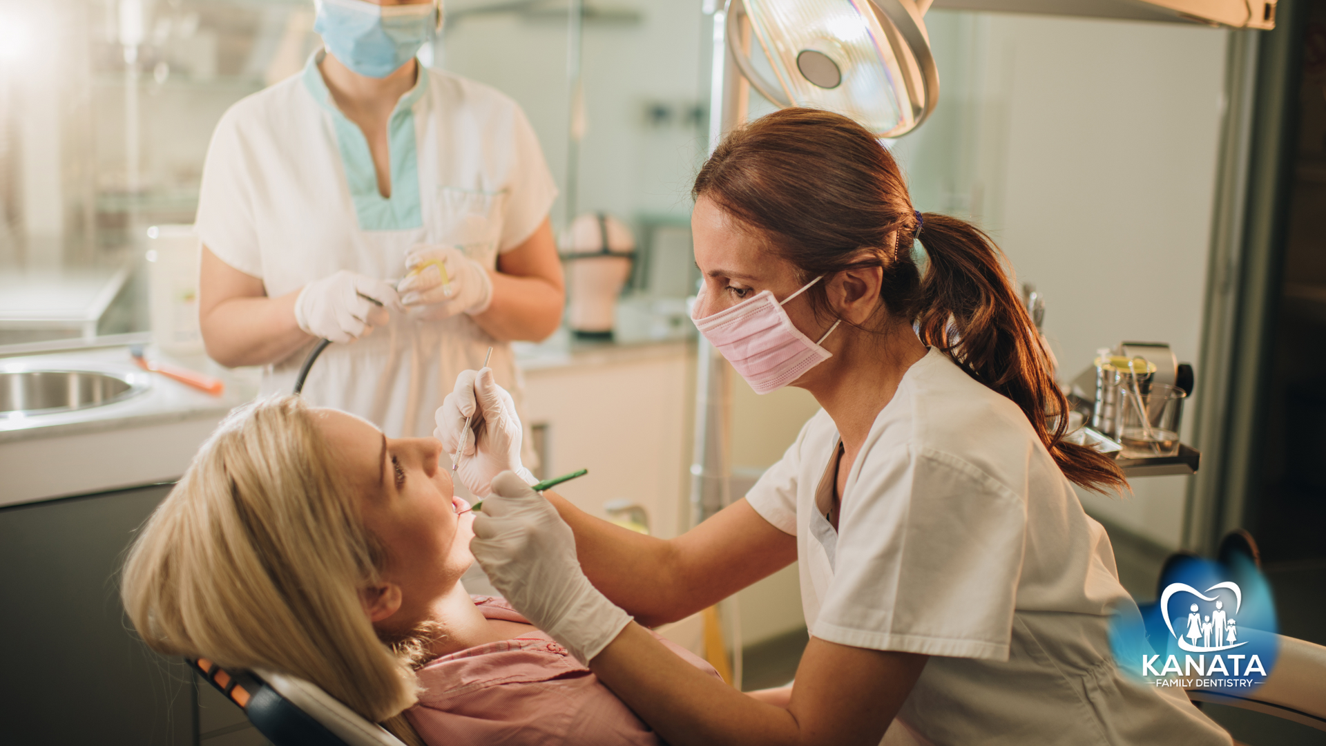 A woman is getting her teeth examined by a dentist in a dental office.