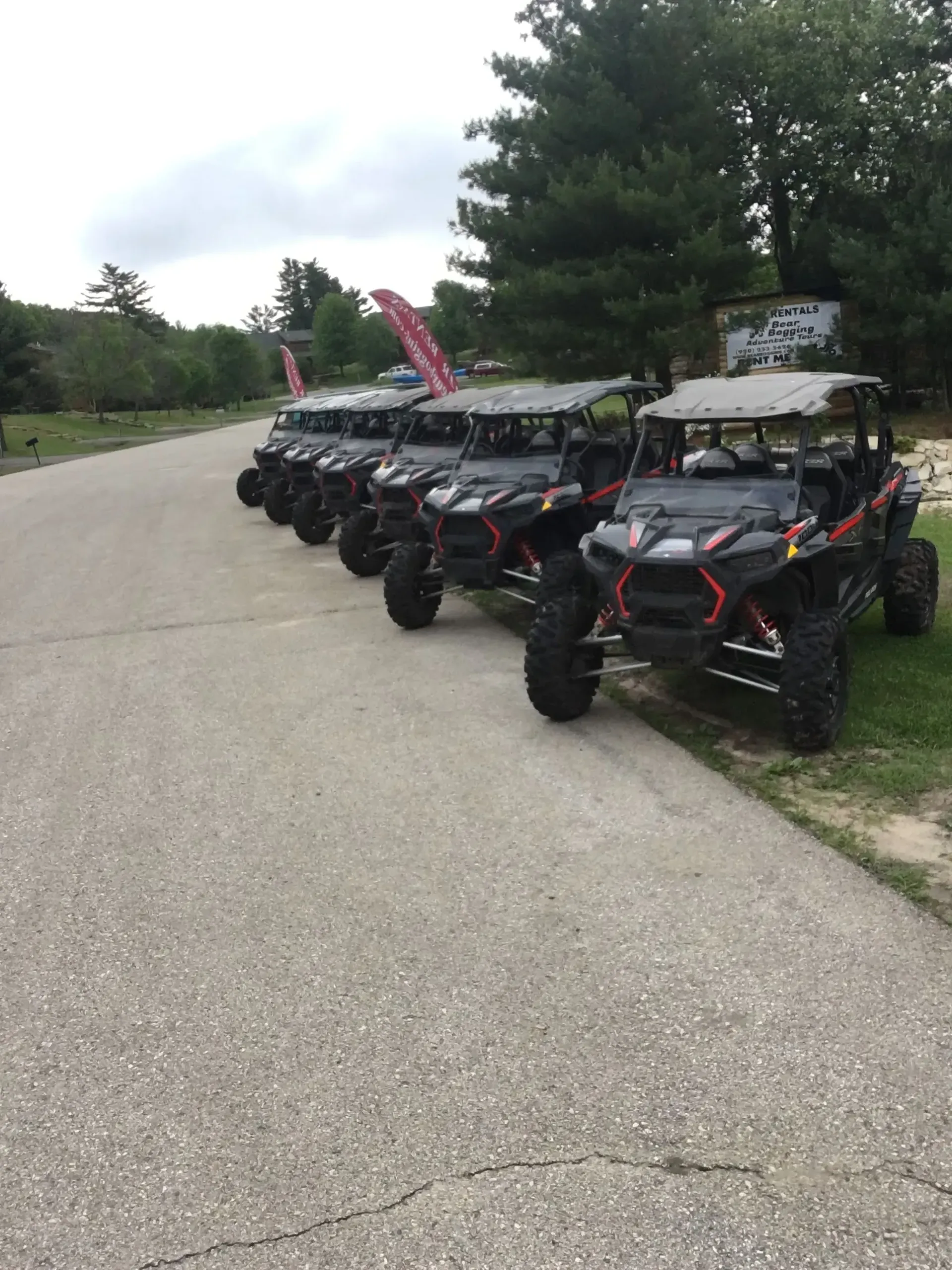 A row of atvs parked on the side of a road.