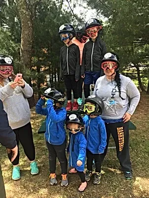 A group of people wearing helmets and goggles are posing for a picture.