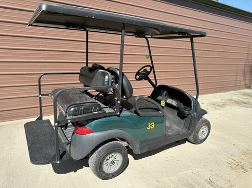 A golf cart is parked on the side of the road