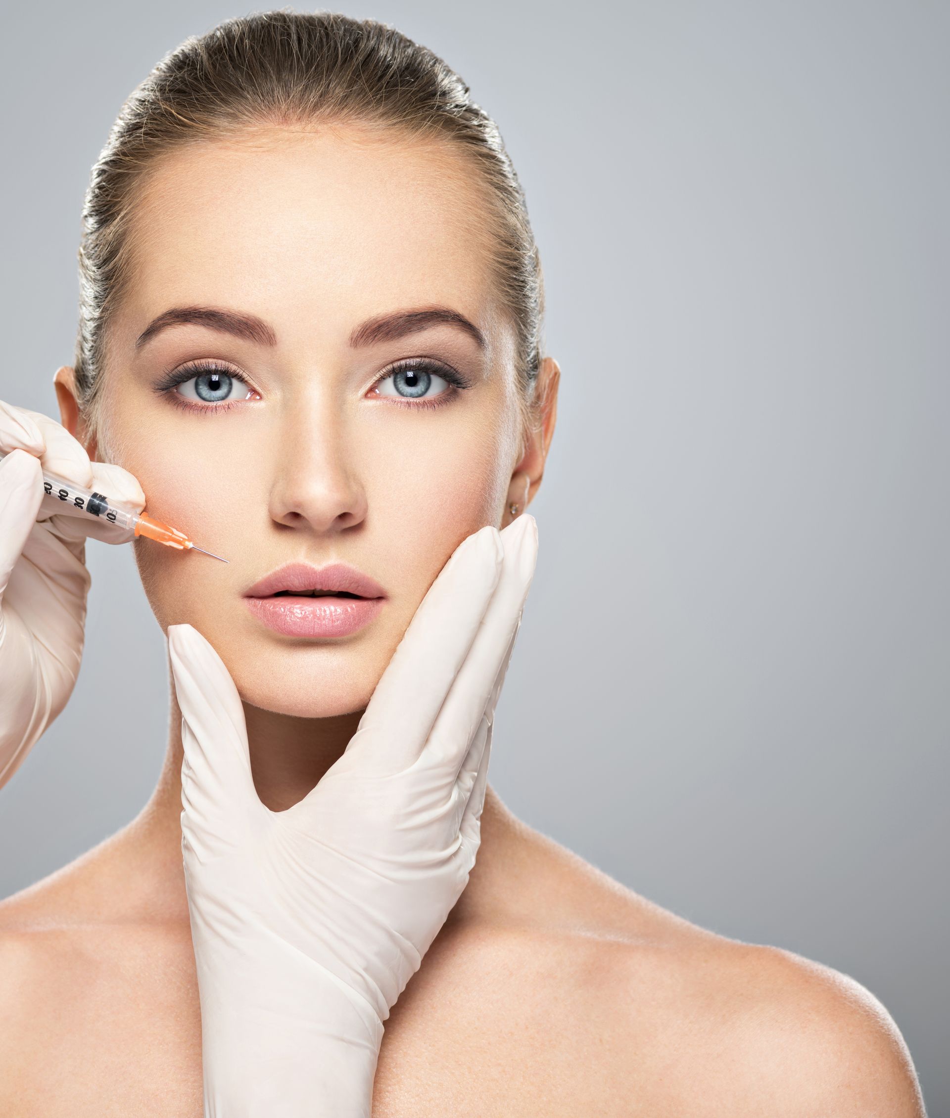 A woman is getting a botox injection in her face.