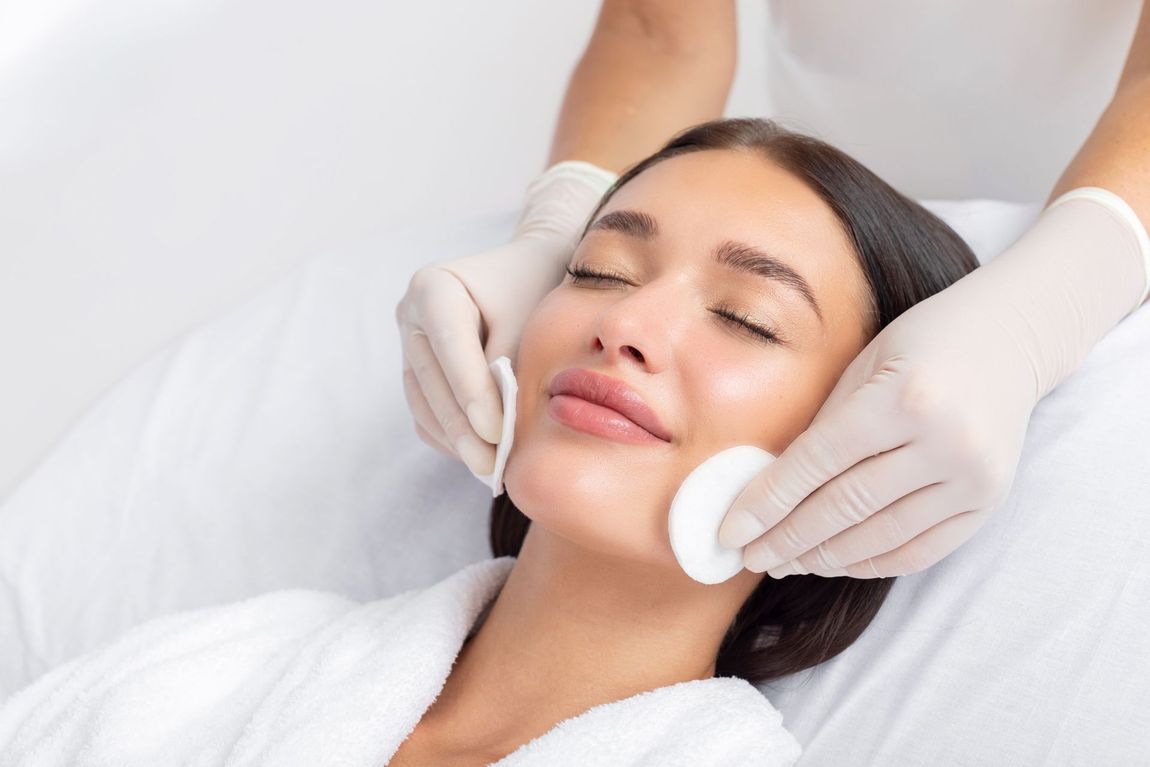 A woman is getting a facial treatment at a spa.