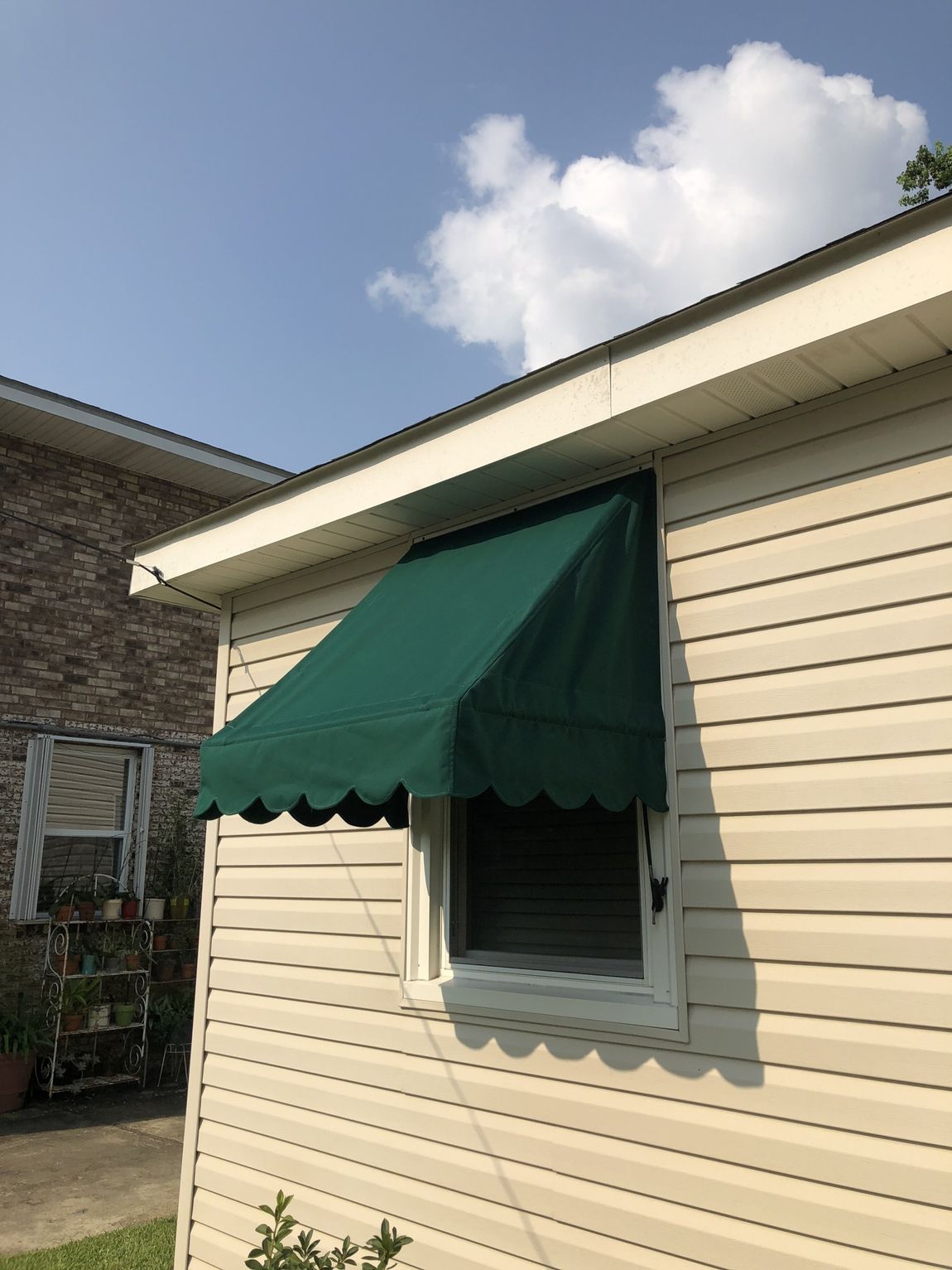 Window Awnings — Window With A Green Awning Installed in Chalmette, LA