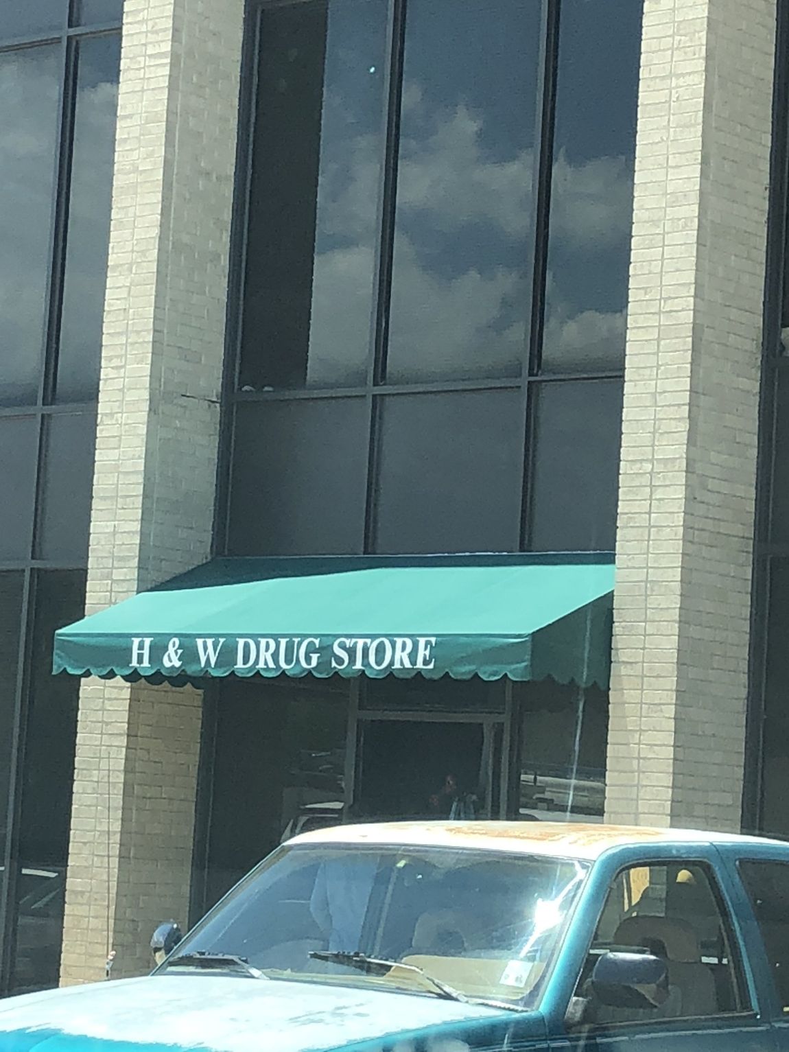 Foster Custom Awnings Portfolio — Green Awnings Installed On A Drug Store in Chalmette, LA