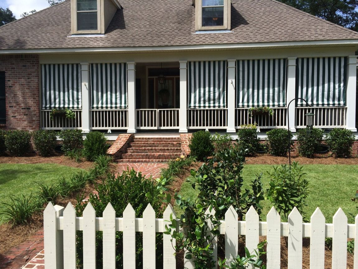 Roll-Up Drop Curtains — Striped Curtain Installed On A House in Chalmette, LA