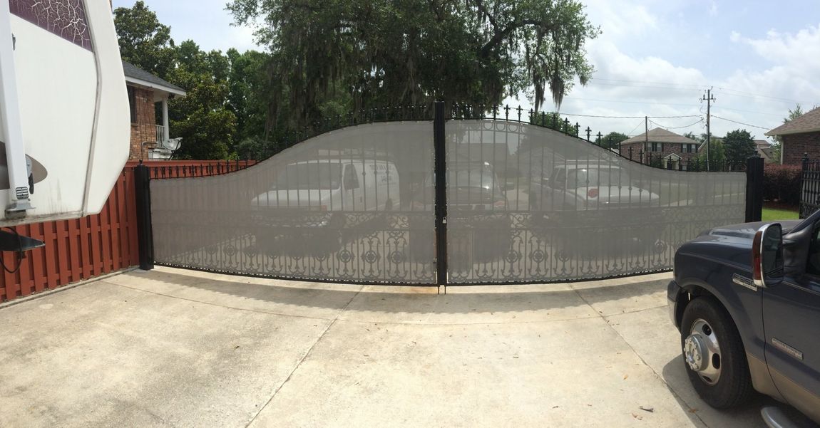 Garage Gates — Huge Gate With Cars Parked Inside in Chalmette, LA