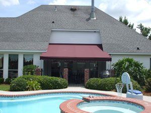 Standing Seam Awnings — Red Awnings Installed In Front Of The House in Chalmette, LA