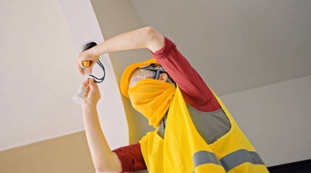Electrician installing circuits, highlighting residential electrical contractors professionalism.
