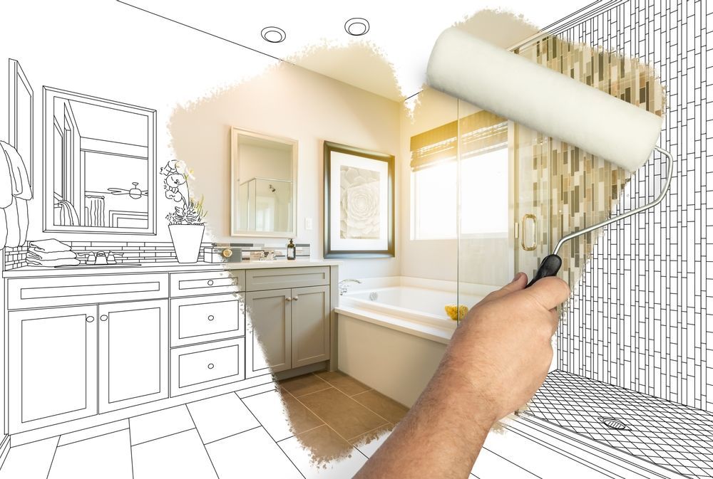 Hand painting a bathroom design with a roller; concept of renovation.