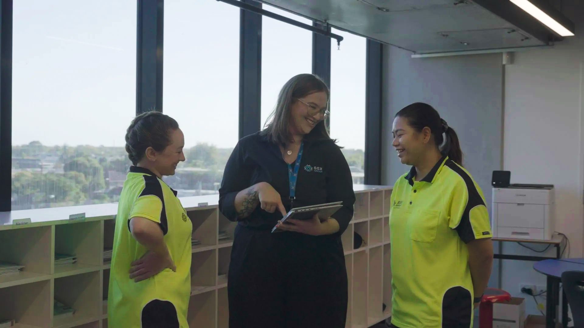 A group of women are standing next to each other in a room.