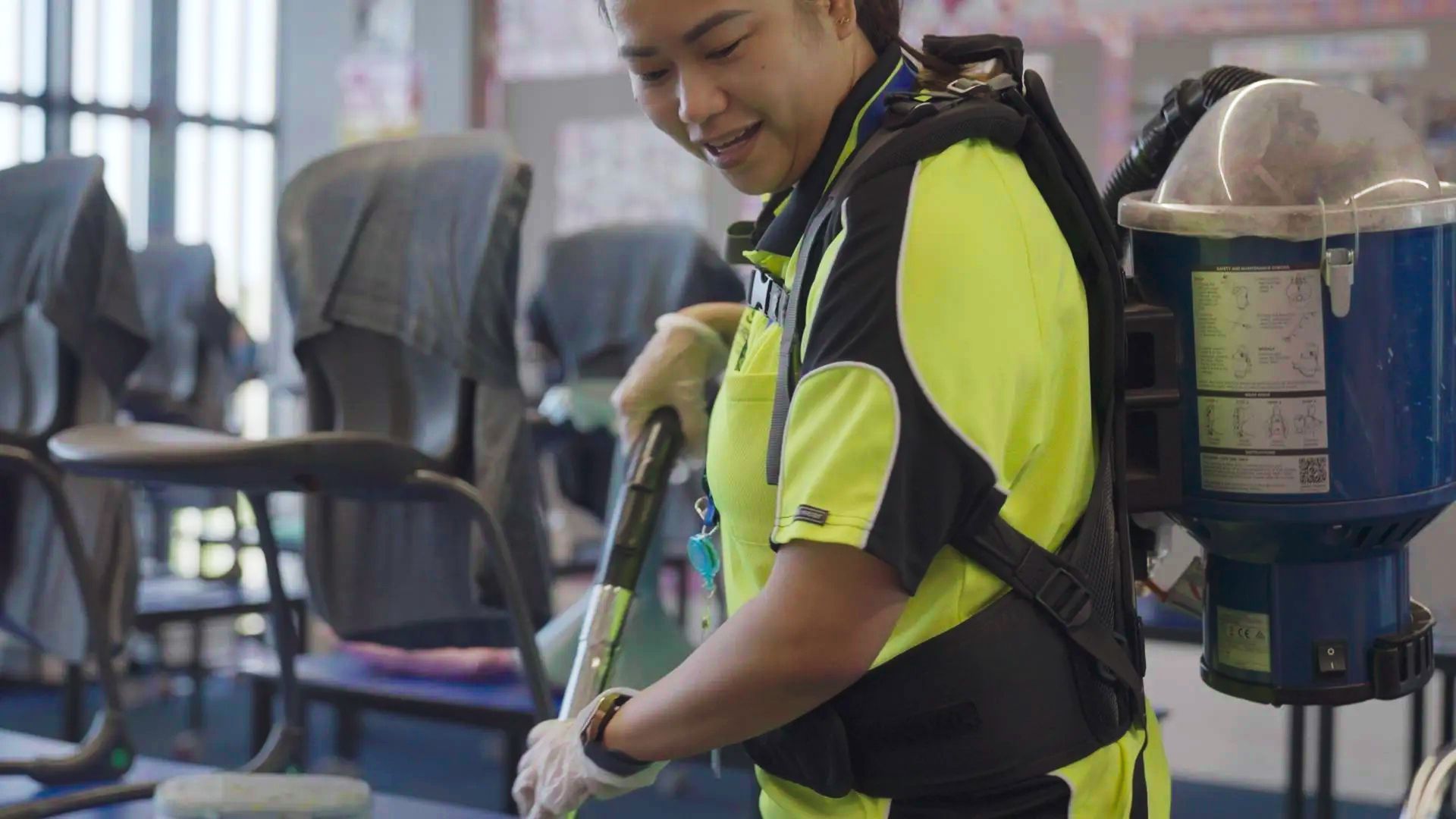 A woman is cleaning the floor with a mop in a room.