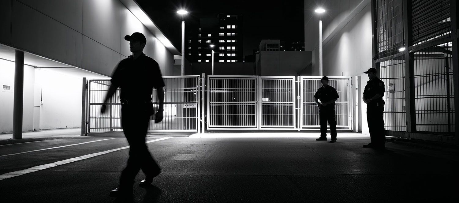 A group of people are walking in a lobby in a black and white photo.