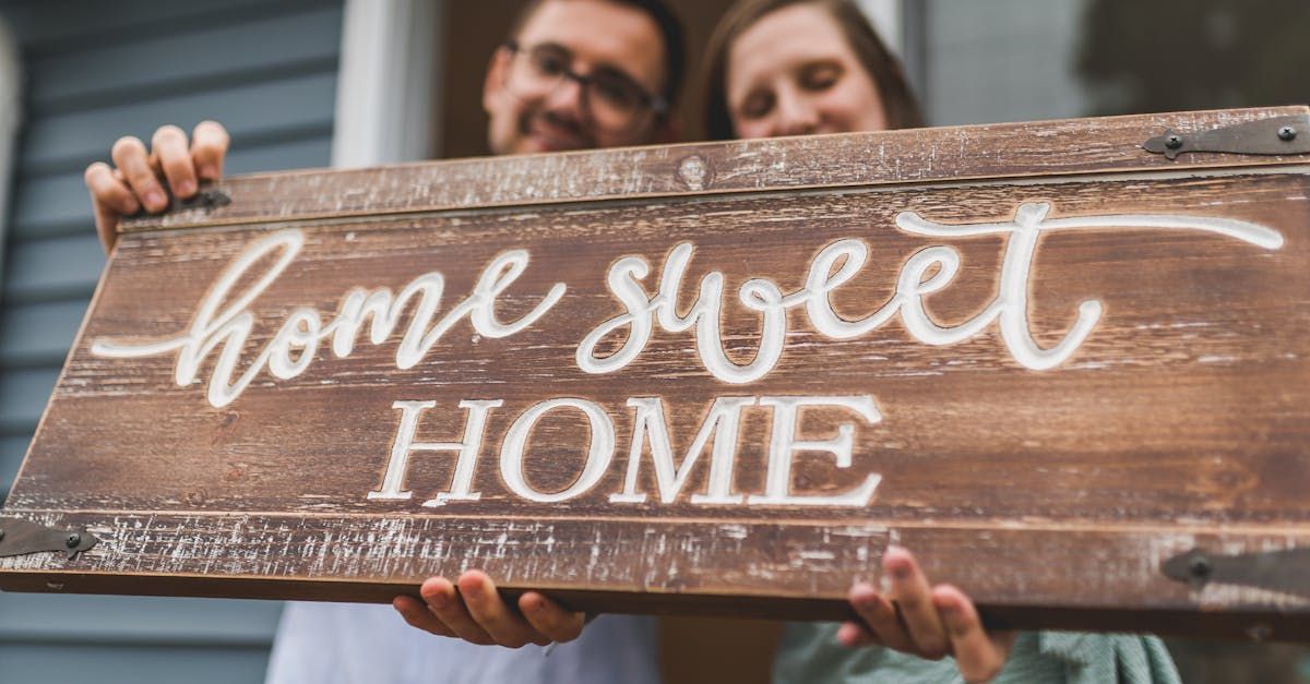 A woman is holding a sold sign in her hands