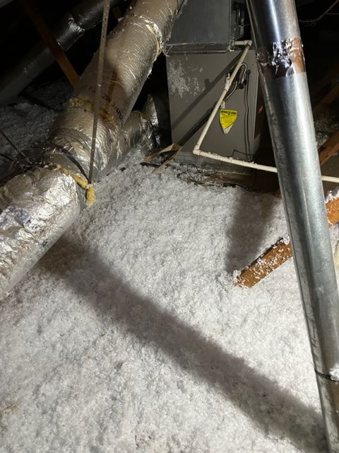 Lot of insulation in the attic of a house.