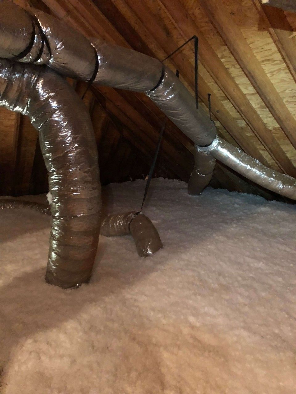 There are a lot of pipes in the attic.