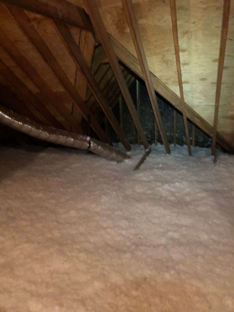 The attic of a house with insulation.