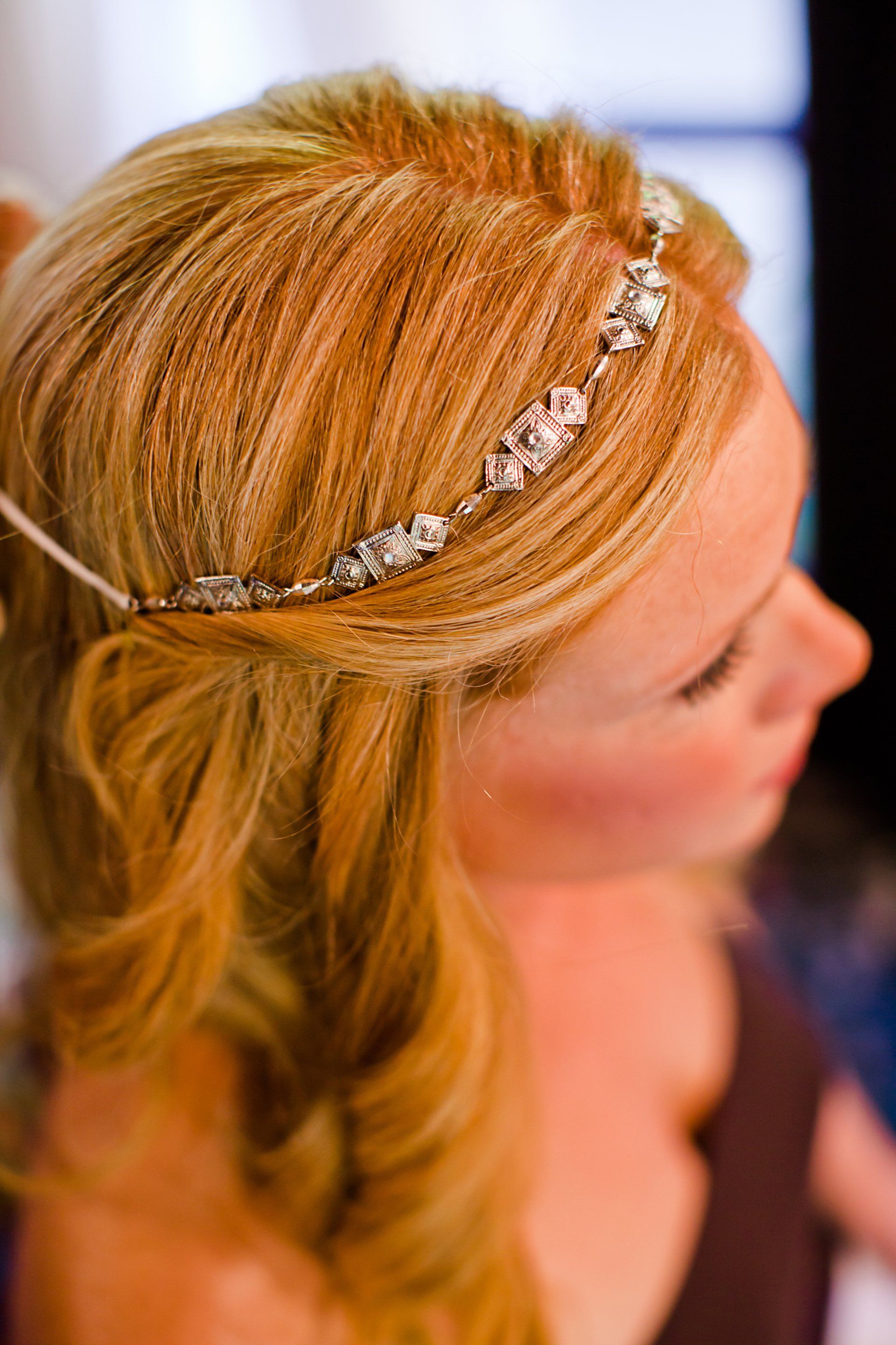 A woman is wearing a headband in her hair.