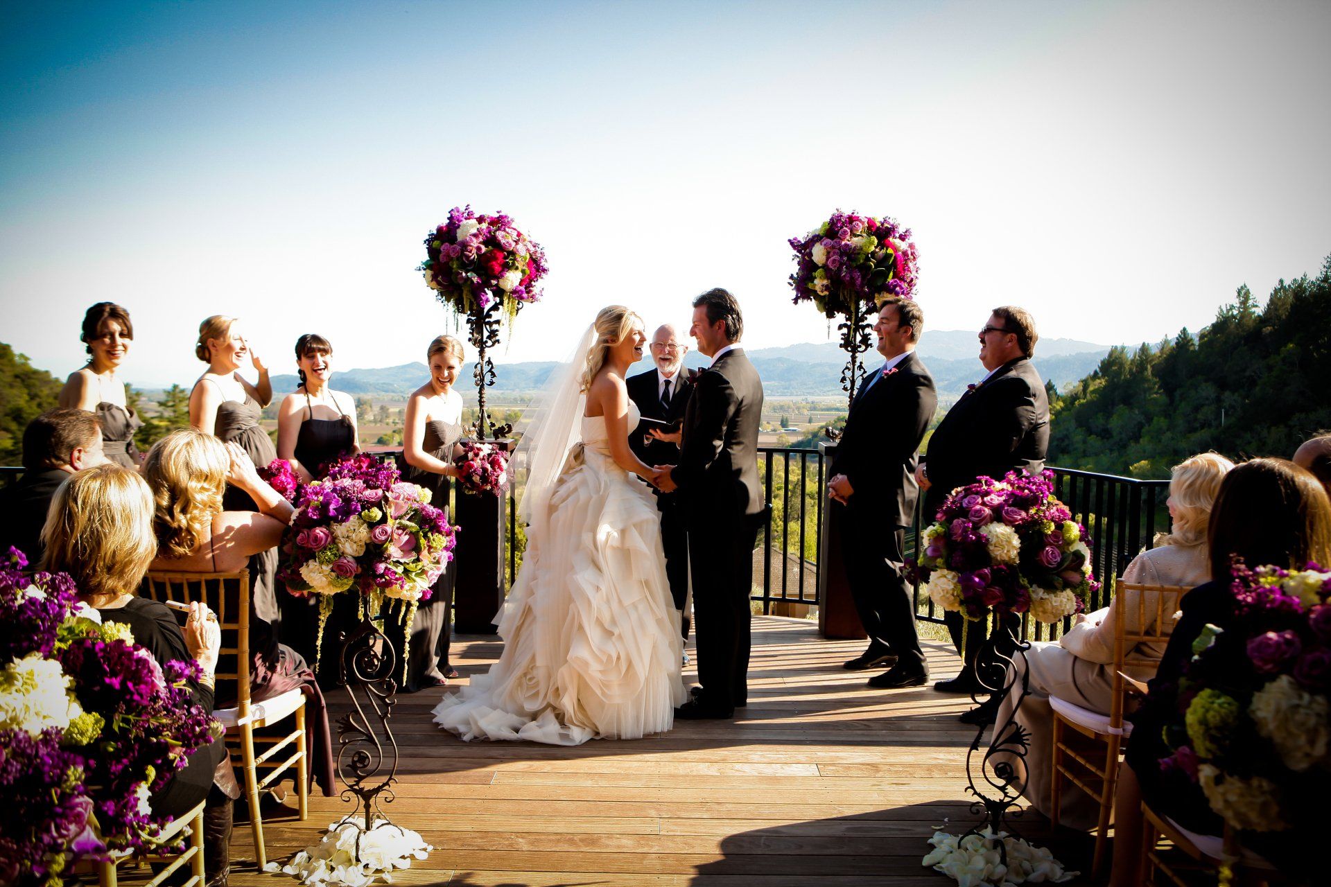 A bride and groom are getting married in front of a crowd of people