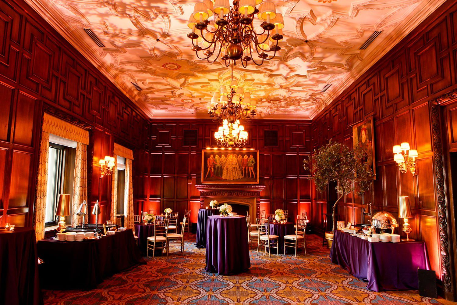 A large room with tables and chairs and a chandelier
