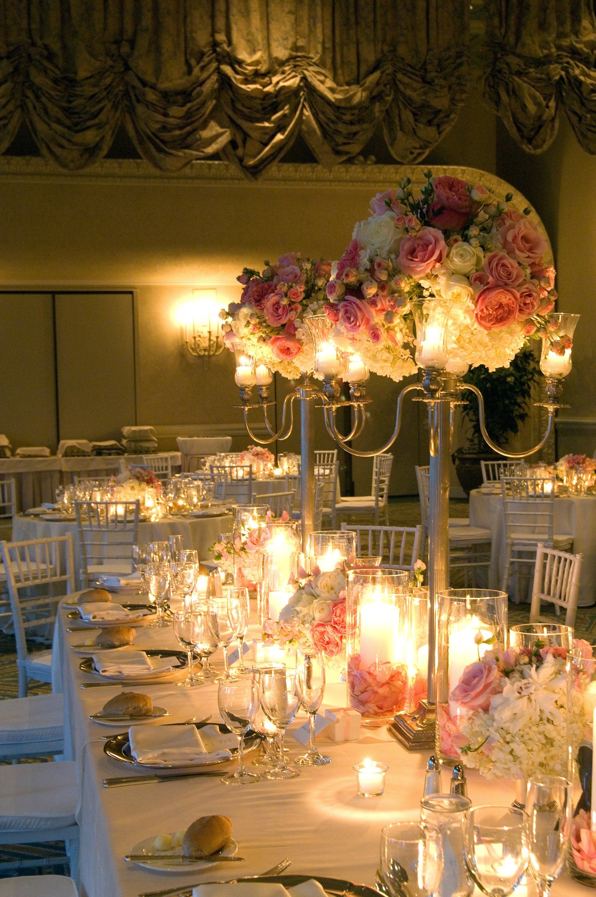 A long table with candles and flowers on it