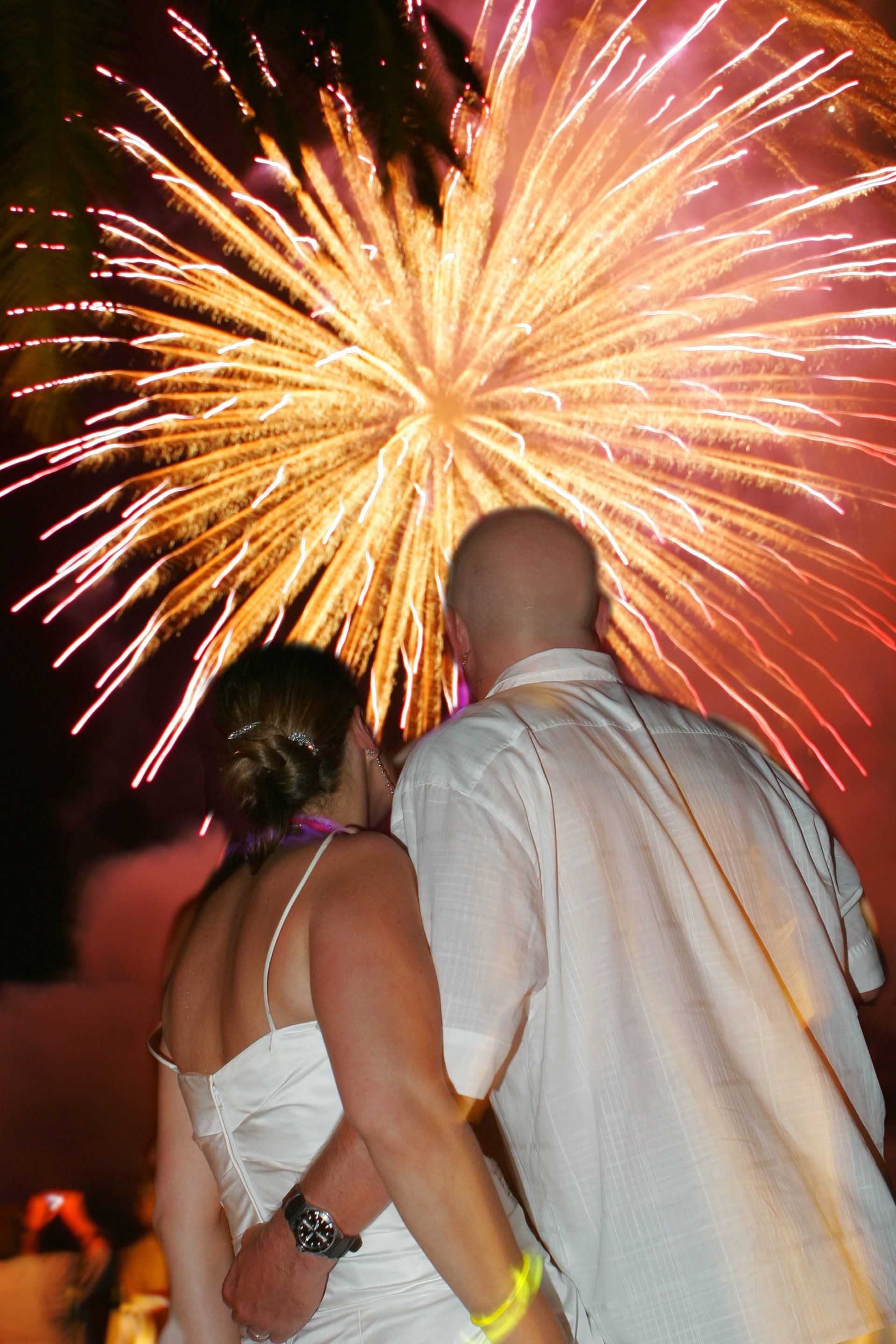 A man and a woman are watching fireworks together