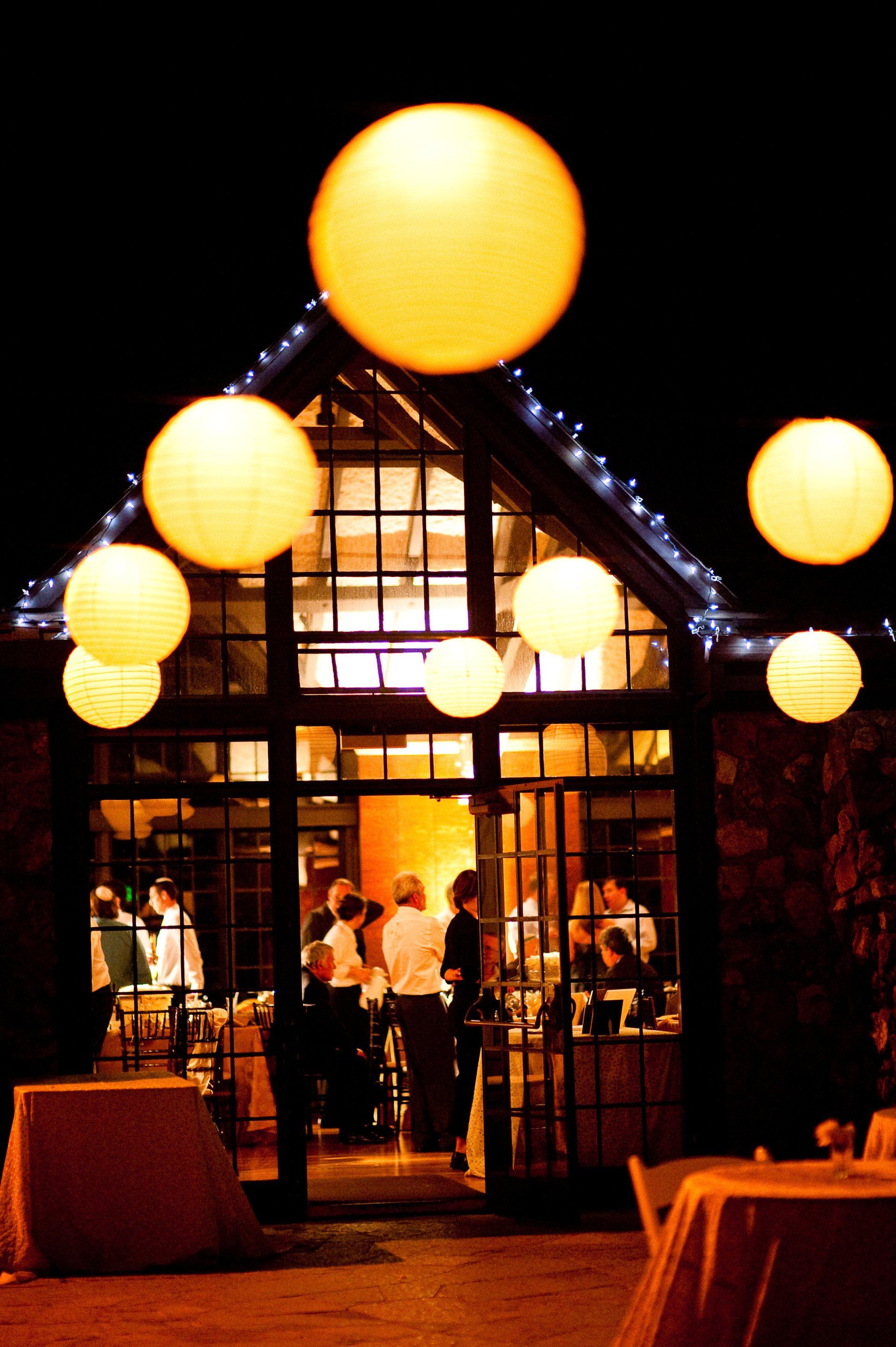 A group of people are gathered outside of a building at night