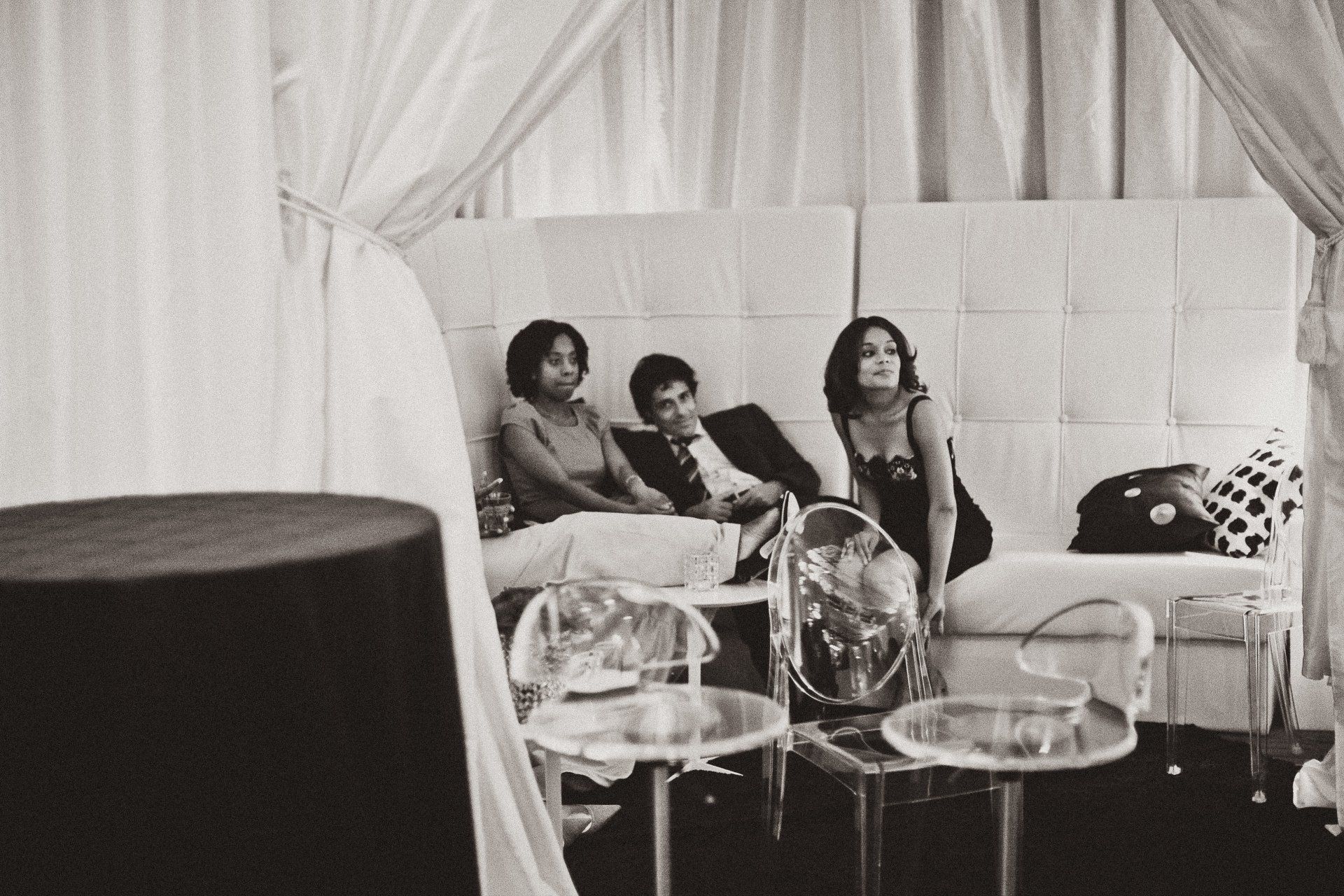 A black and white photo of people sitting on a couch