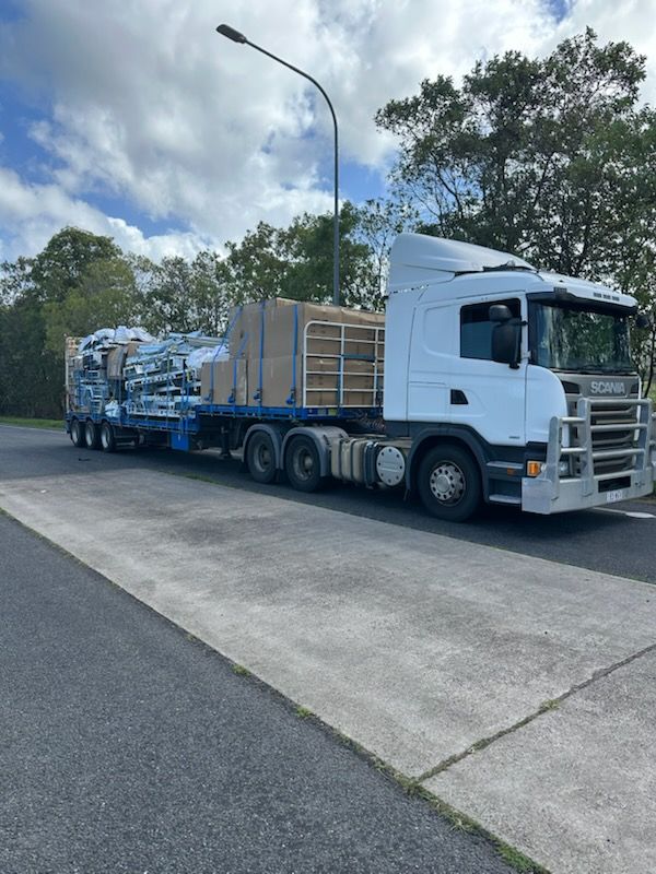 White Semi-truck Hauling Flatbed Trailer — Alfie's Towing in Georgetown, QLD