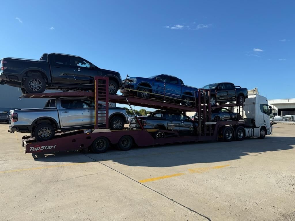 Car Carrier Truck Loaded With Several Pickup Trucks — Alfie's Towing in Townsville, QLD
