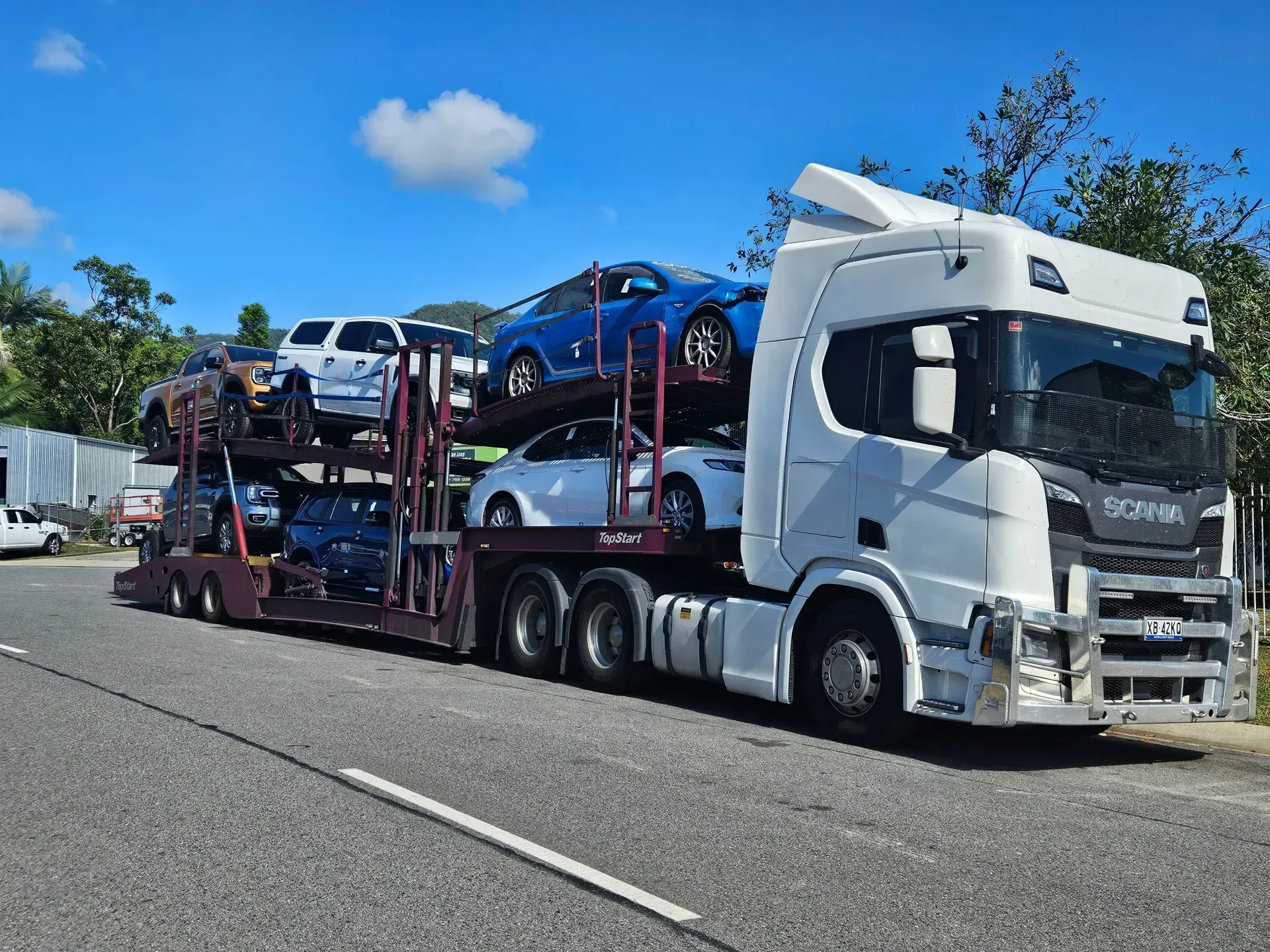 A White Semi-truck Carrying Multiple Cars on a Multi-level Trailer — Alfie's Towing in Mareeba, QLD