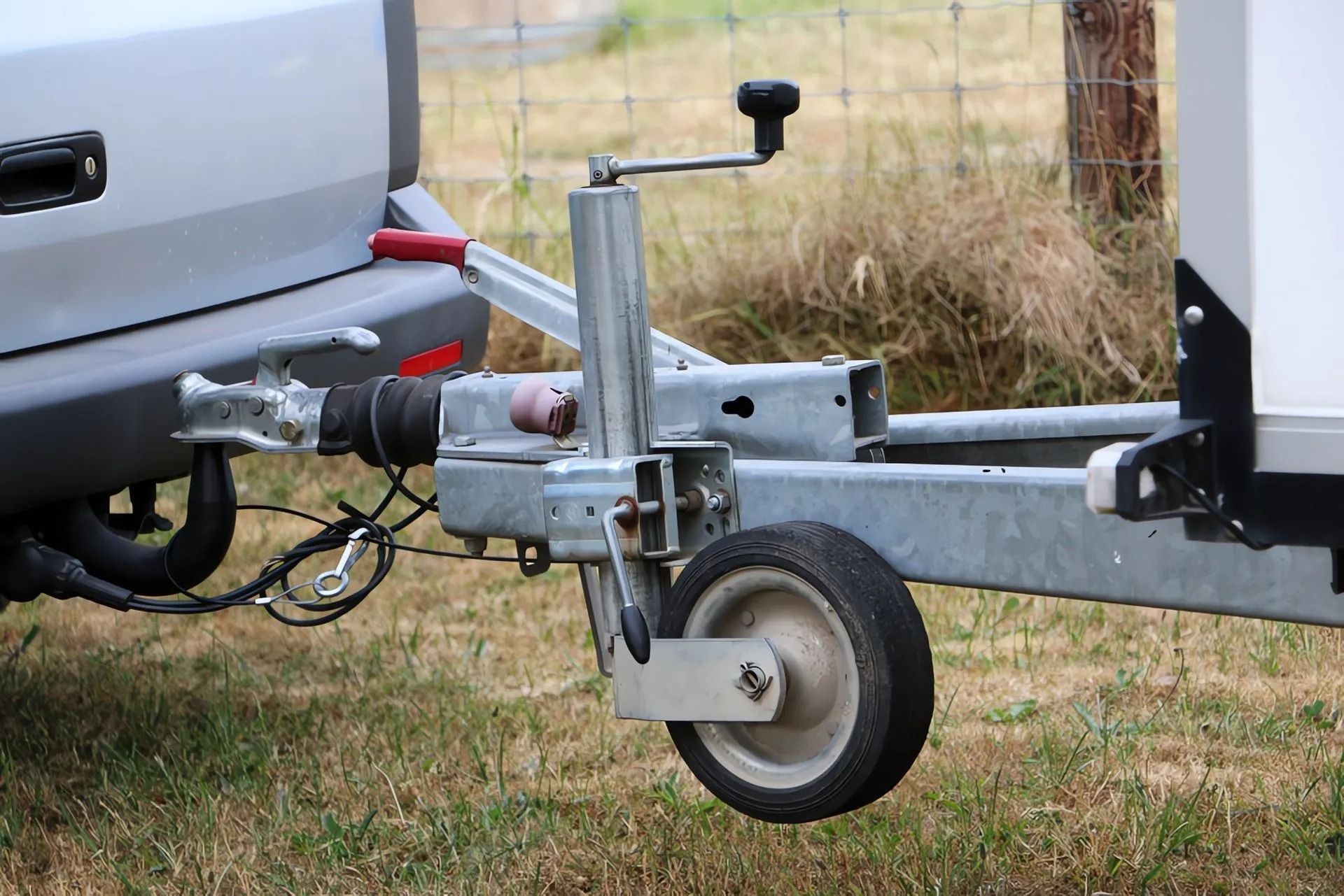 Trailer Hitch Attached to a Vehicle With a Jockey Wheel on the Trailer for Support — Alfie's Towing in Ravenshoe, QLD