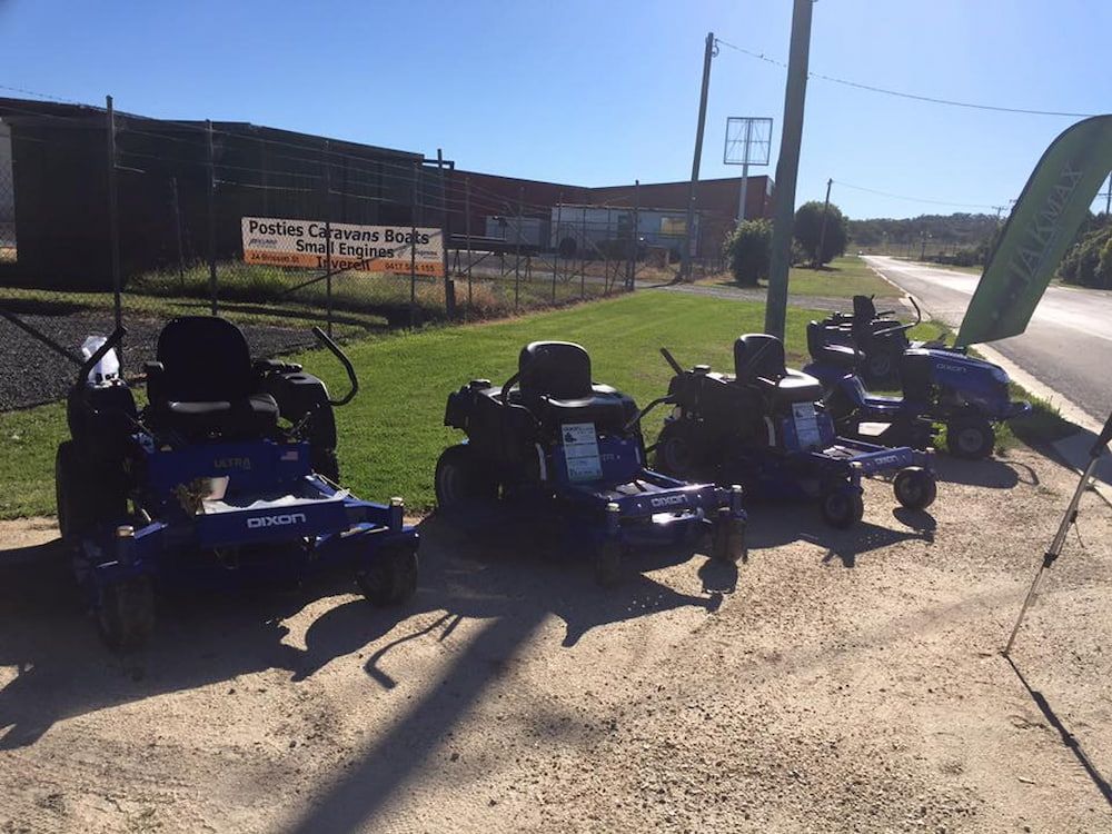 A Row Of Lawn Mowers Are Parked On The Side Of The Road — Posties Caravans Boats Small Engines Inverell In Inverell, NSW