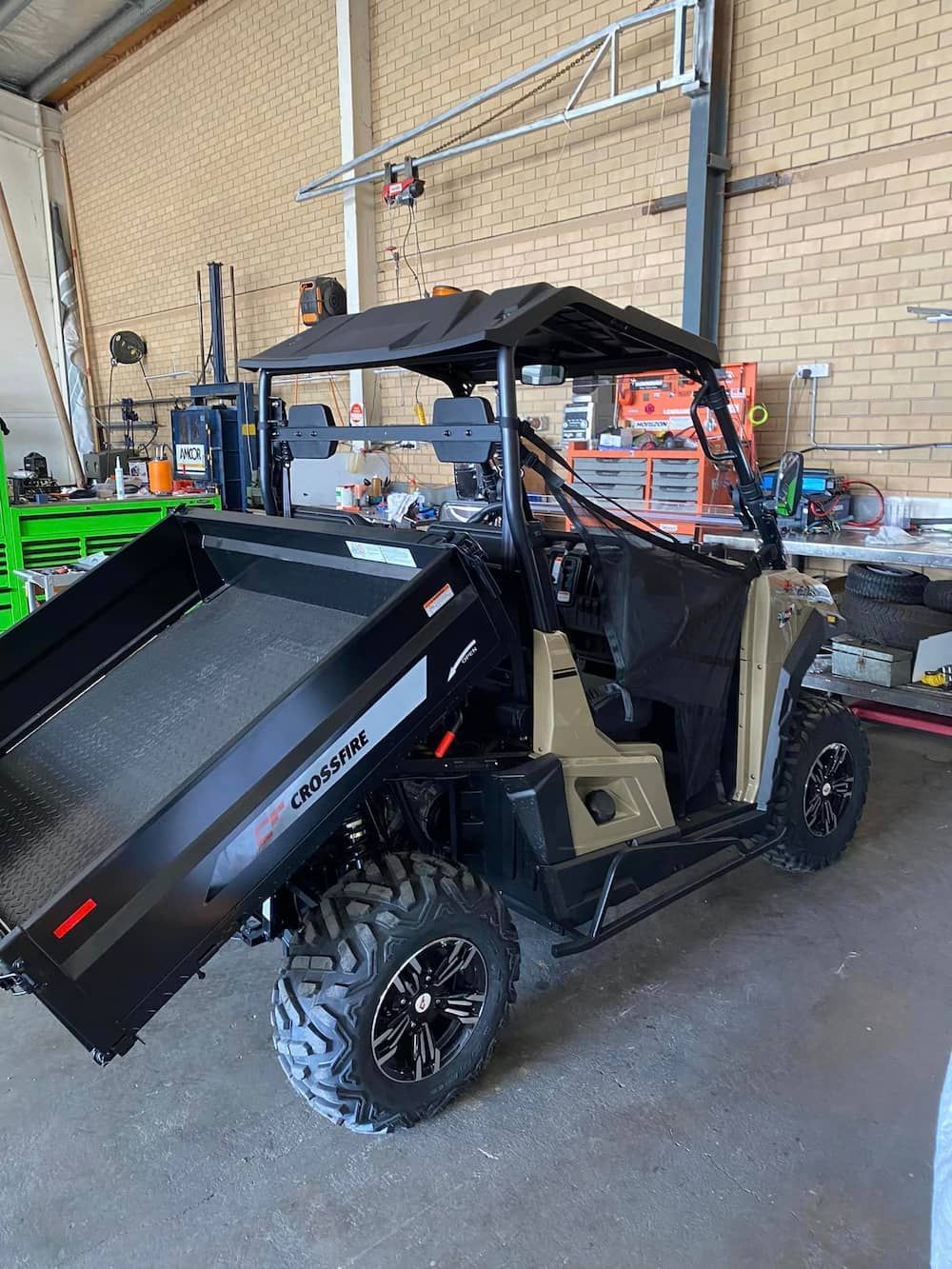 A Utility Vehicle Is Parked In A Garage Next To A Brick Wall — Posties Caravans Boats Small Engines Inverell In Inverell, NSW