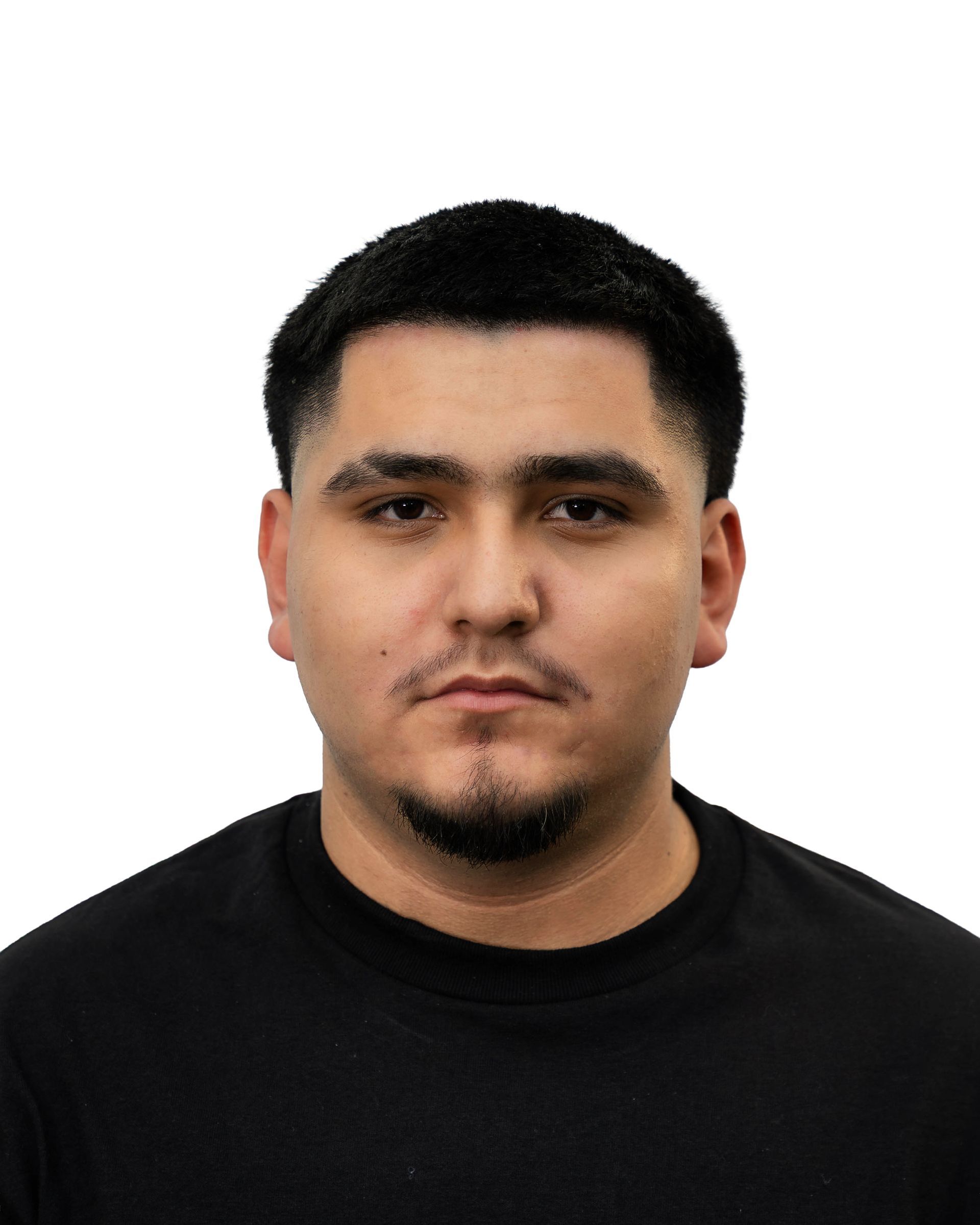 Man with dark hair and a short beard, wearing a black shirt, looking directly at the camera.