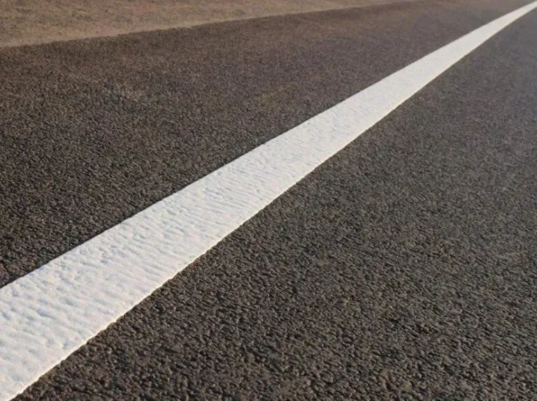 A white line is painted on the side of a road