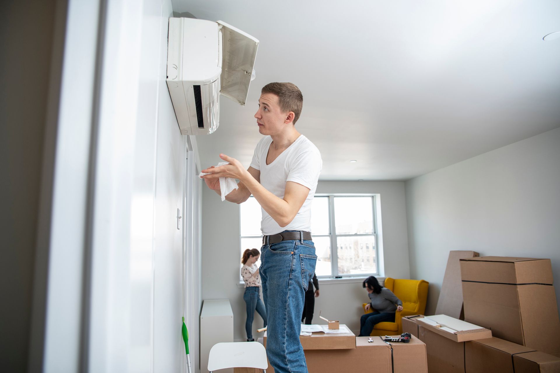Young Man Installing Ductless System — Auburndale, FL — Snowbird Heating and Cooling