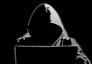 Silhouette of person in a hoodie, at a laptop, likely hacking with silver outline and dark background.