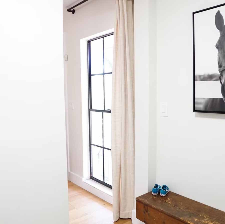 There is a picture of a horse on the wall in the hallway.