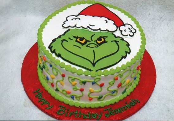 A birthday cake with a grinch face on it