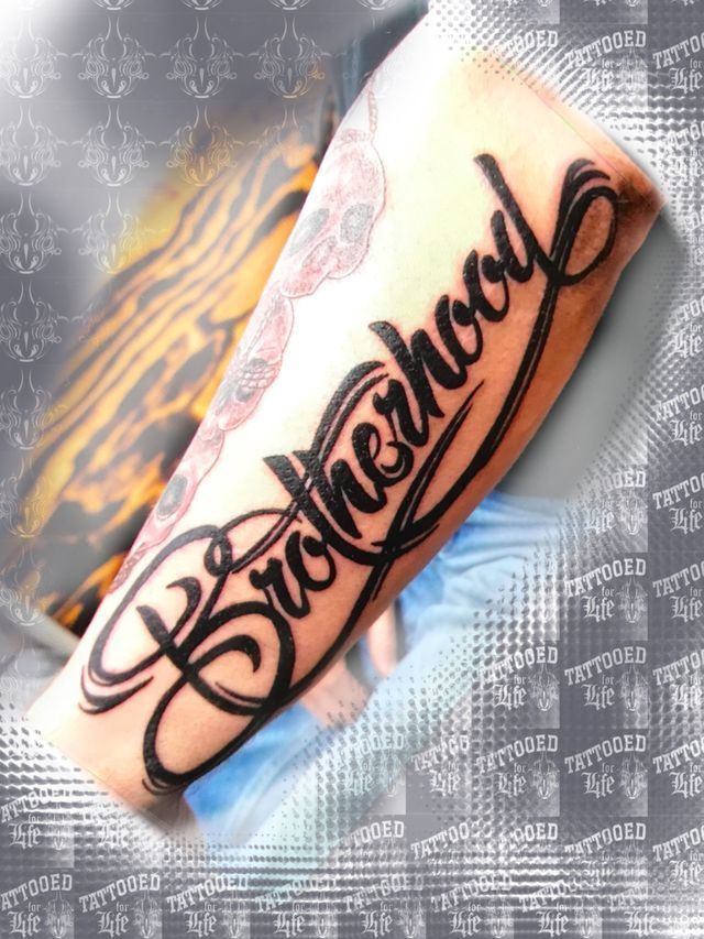 A tattoo of the word brotherhood on a person 's arm
