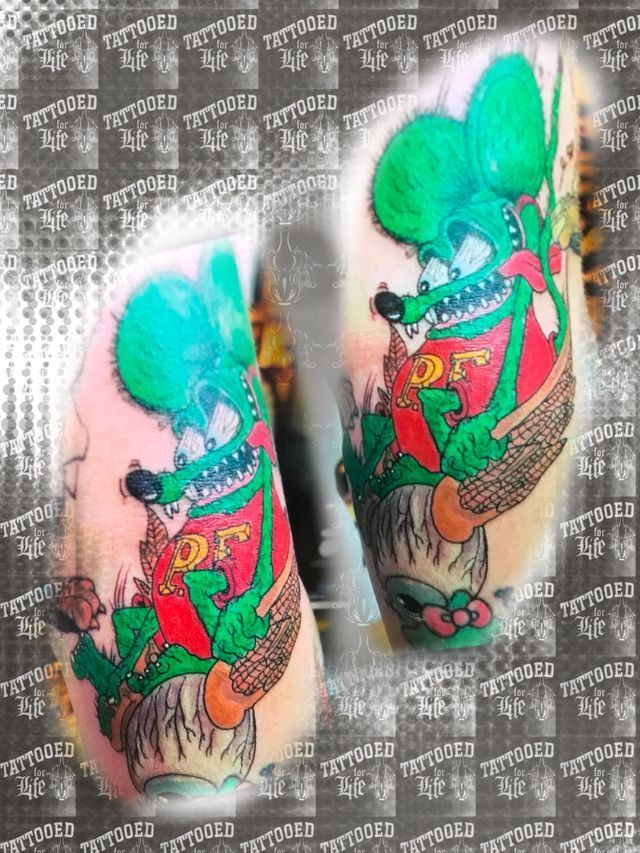 A tattoo of a rat on a person 's arm.