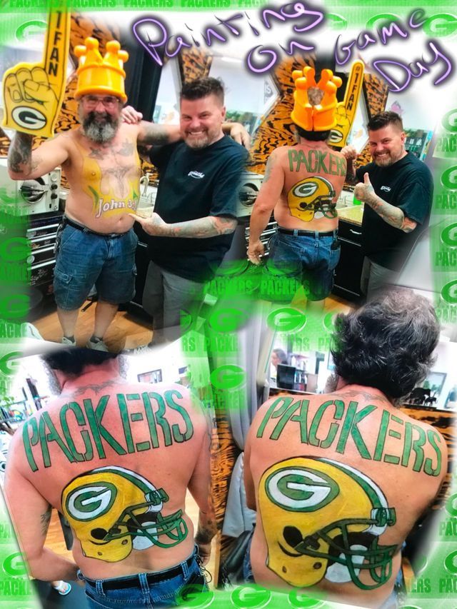 A man with the word packers painted on his back