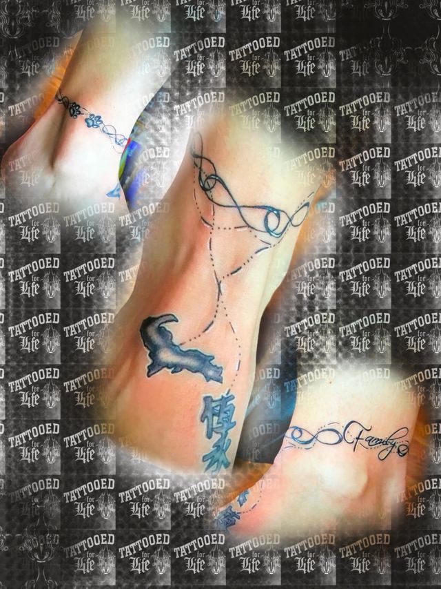 A woman has a tattoo of a dolphin on her arm.