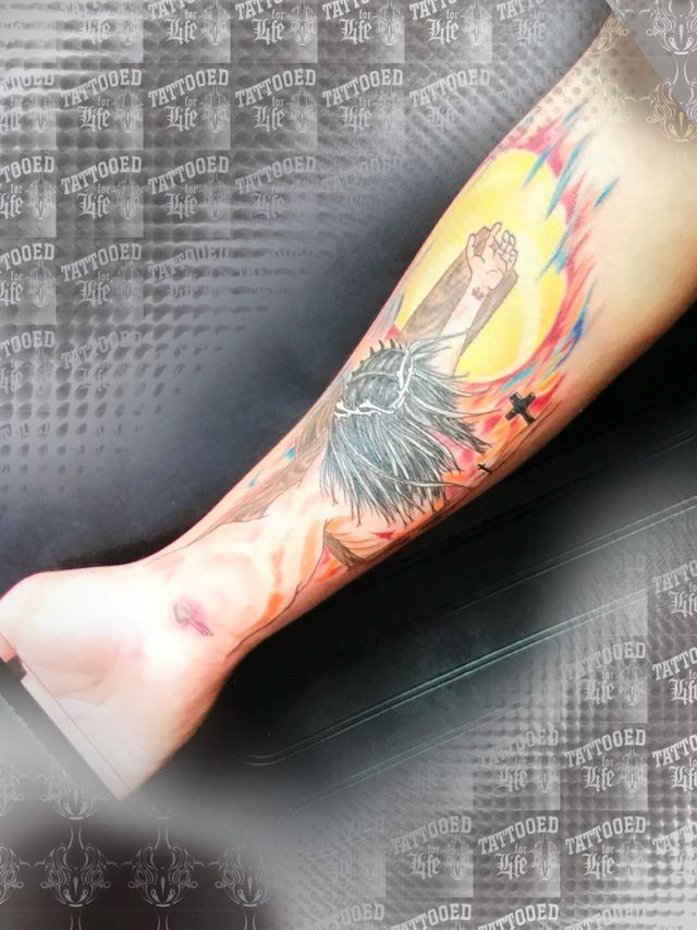 A person has a tattoo on their forearm that looks like a phoenix