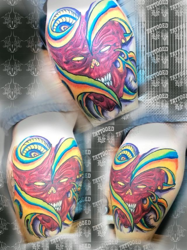 A person has a colorful tattoo on their leg.