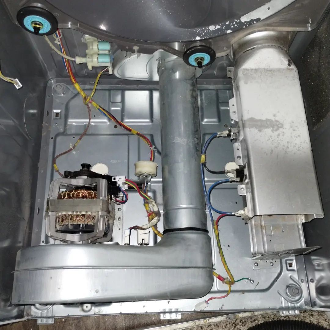 Person using a power drill on a window frame, indoors.