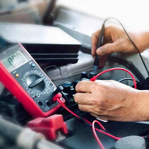Auto Electrical Service — Mechanic Checking the Battery in Santa Cruz, CA